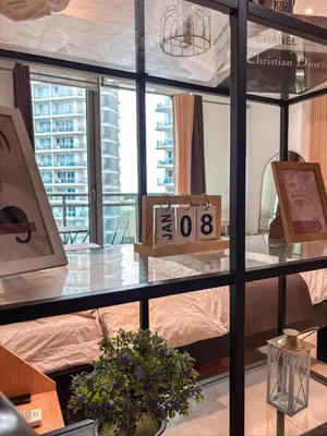 a room with a bed and a table with a clock at Casa Del Sol in Manila