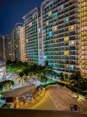 a view of a large building with palm trees and a beach at Casa Del Sol in Manila