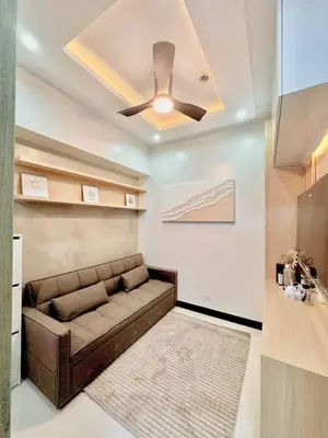 a living room with a couch and a ceiling fan at Sleek Urban Staycation-2BR with Manila Bay View near MOA, PICC, World Trade Center and US Embassy in Manila