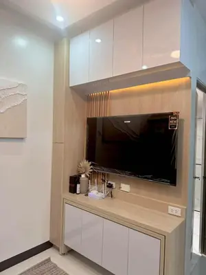 a living room with a flat screen tv on a wall at Sleek Urban Staycation-2BR with Manila Bay View near MOA, PICC, World Trade Center and US Embassy in Manila