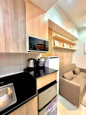 a small kitchen with a sink and a microwave at Sleek Urban Staycation-2BR with Manila Bay View near MOA, PICC, World Trade Center and US Embassy in Manila