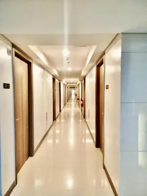a corridor of an office building with a long hallway at Sleek Urban Staycation-2BR with Manila Bay View near MOA, PICC, World Trade Center and US Embassy in Manila