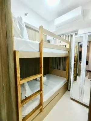 a room with two bunk beds in it at Sleek Urban Staycation-2BR with Manila Bay View near MOA, PICC, World Trade Center and US Embassy in Manila