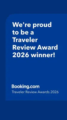 a blue sign that says were proud to be a traveler reviewagency winner at Sleek Urban Staycation-2BR with Manila Bay View near MOA, PICC, World Trade Center and US Embassy in Manila