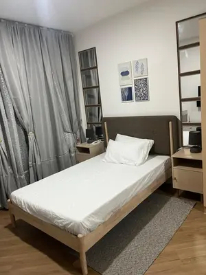 a bedroom with a bed with white sheets and a window at Veranda Arca South in Manila