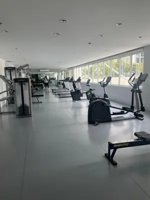 a gym with a row of treadms and cardio machines at Veranda Arca South in Manila