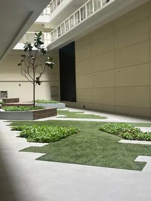 a courtyard with a tree in the middle of a building at Veranda Arca South in Manila