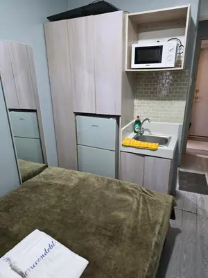 a small kitchen with a sink and a microwave at nicecondotel in Manila