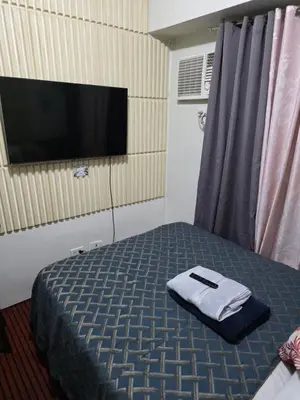 a hotel room with a bed with a towel on it at nicecondotel in Manila