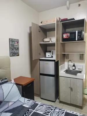 a small kitchen with a sink and a stove at Staycation Condotel Urban Deca Tower Edsa Mandaluyong in Manila