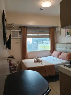 a small room with two beds and a window at Staycation Condotel Urban Deca Tower Edsa Mandaluyong in Manila