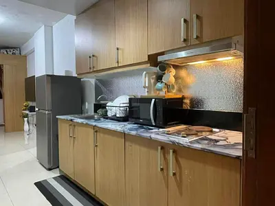 a kitchen with a microwave and a refrigerator at Spacious One Bedroom Unit in MOA in Manila