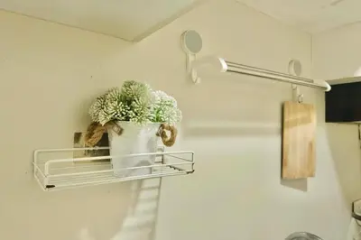 a plant in a pot on a shelf on a wall at Chic Getaway Near Airport in Manila