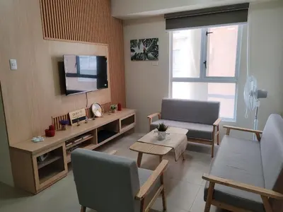 a living room with a couch and a tv at Chic Getaway in Sucat in Manila