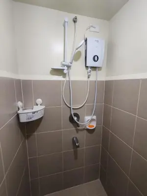 a shower in a bathroom with a shower head at Chic Getaway in Sucat in Manila