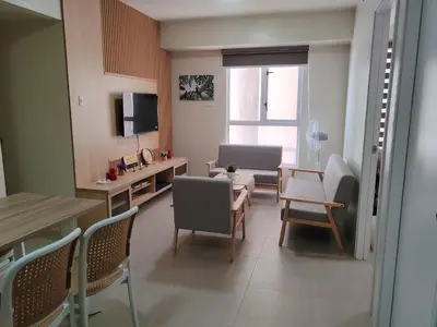 a small living room with a table and chairs at Chic Getaway in Sucat in Manila