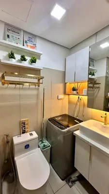 a bathroom with a toilet and a sink at Warm & Homey Staycation Suite in Manila
