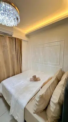 a room with a bed with a hat on it at Warm & Homey Staycation Suite in Manila