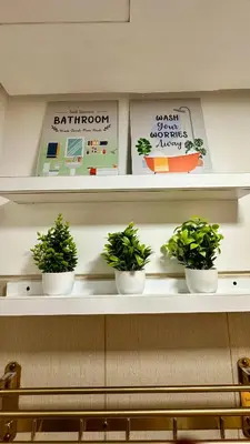 three potted plants sitting on a shelf in a room at Warm & Homey Staycation Suite in Manila