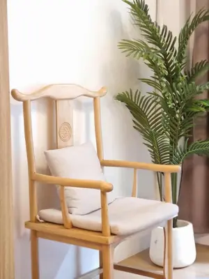 a wooden chair sitting next to a potted plant at 953 D shore 1 in Manila
