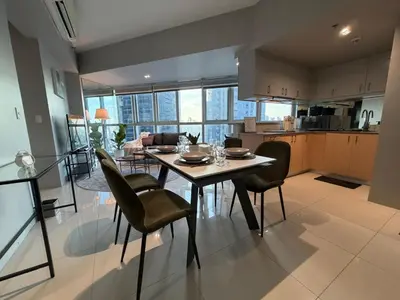 a kitchen and dining room with a table and chairs at High View Suite in BGC with Swimming Pool in Manila