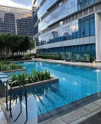 a large swimming pool in front of a building at High View Suite in BGC with Swimming Pool in Manila