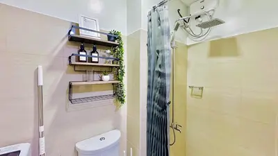 a bathroom with a shower and a toilet in it at 1 Bedroom Unit near MOA & NAIA Terminal in Manila