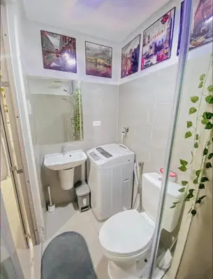a small bathroom with a toilet and a sink at Shore Residence Tower A w Pool Near Airport and MOA in Manila