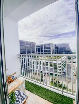 a balcony with a view of a building at Shore Residence Tower A w Pool Near Airport and MOA in Manila