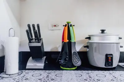 a kitchen counter with utensils on a counter top at Shore Residence Tower A w Pool Near Airport and MOA in Manila