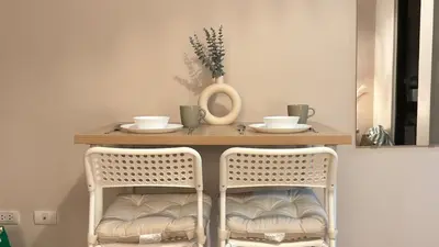 a table with two chairs and a table with two cups at Cozy Studio in Salcedo Village Makati City in Manila