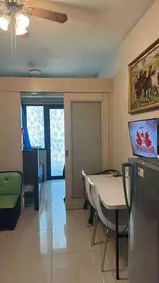 a living room with a table and a dining room at MamiChai Place in Manila