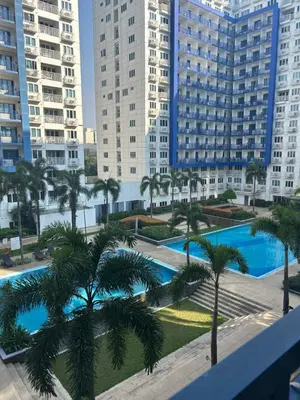 a view from the balcony of a building with palm trees at MamiChai Place in Manila