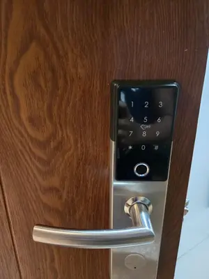 a close up of a door handle on a wooden door at J&W Homestay in Manila