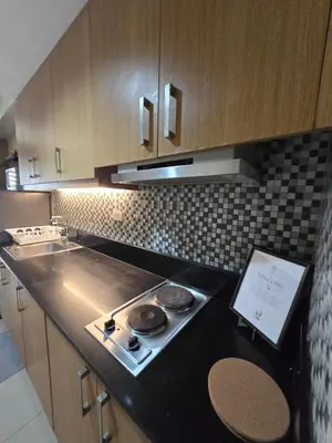 a kitchen with a stove and a counter top at J&W Homestay in Manila
