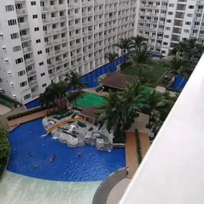 an aerial view of a large swimming pool in a resort at Two-Bedroom by Metro Staycation in Manila