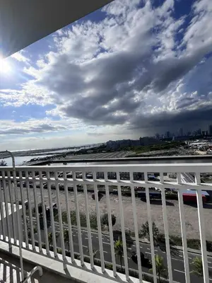 a view of the beach from the balcony of a building at 2 ROOMS 1 UNIT by Metro Staycation in Manila