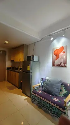 a kitchen with a couch and a refrigerator at 2 ROOMS 1 UNIT by Metro Staycation in Manila