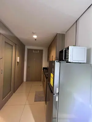 a kitchen with a refrigerator and a microwave at 2 ROOMS 1 UNIT by Metro Staycation in Manila
