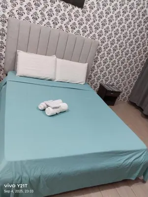 a blue bed with a stuffed animal sitting on it at Gambino Homes in Manila
