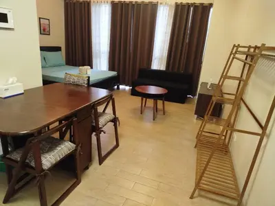 a living room with a desk and a ladder at Gambino Homes in Manila