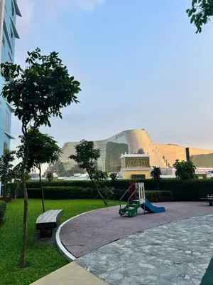 a playground in a park with a building in the background at 3BR Penthouse Suite Sunset View in front of Okada in Manila