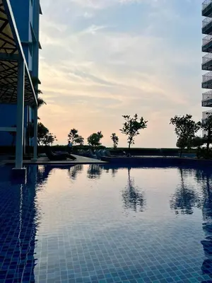 a swimming pool in front of a building at 3BR Penthouse Suite Sunset View in front of Okada in Manila