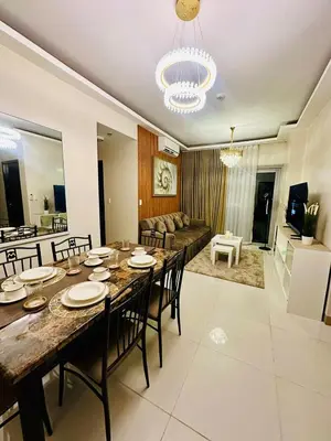 a dining room and living room with a table and chairs at 3BR Penthouse Suite Sunset View in front of Okada in Manila