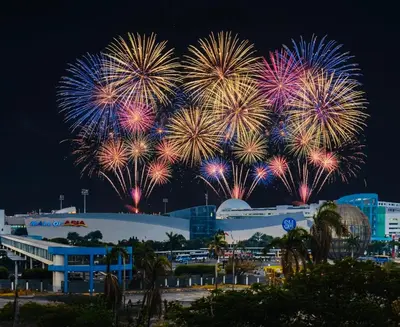 a group of fireworks exploding in the sky over a city at RE Staycations MOA VIEW in Manila
