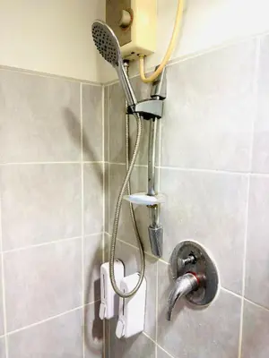a shower in a bathroom with a shower head at RE Staycations MOA VIEW in Manila
