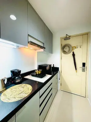 a kitchen with a stove and a counter top at RE Staycations MOA VIEW in Manila