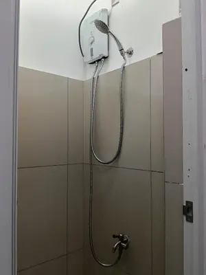 a shower in a bathroom with a shower head at Stay Manila Hostel in Manila