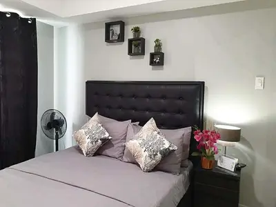 a bedroom with a large bed with pillows on it at Azure Urban Resort Residences in Manila