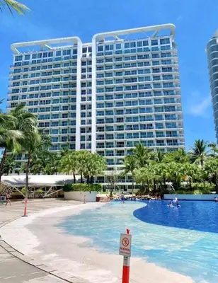 a large building with a pool in front of a resort at Azure Urban Resort Residences in Manila